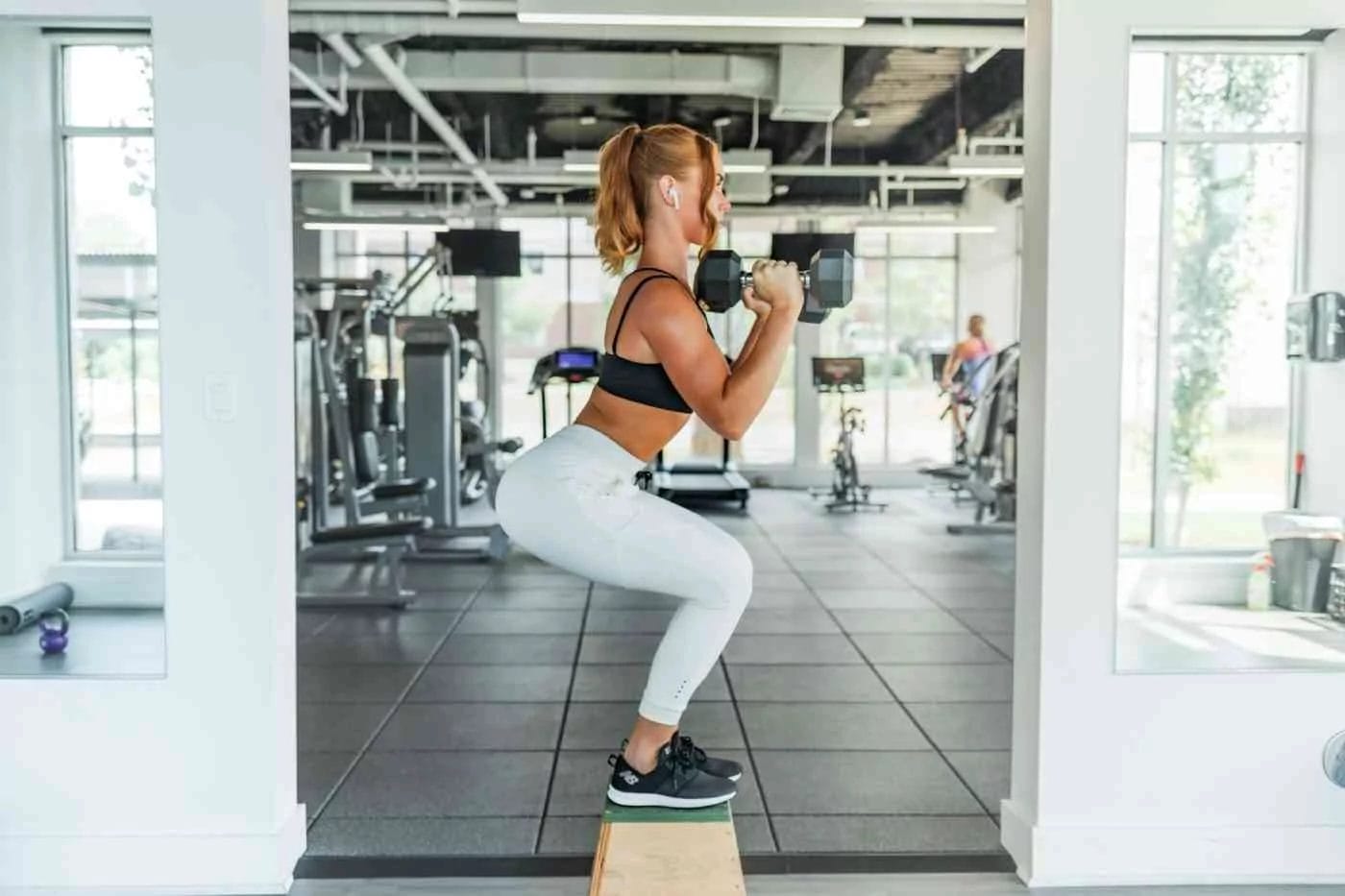 Woman lifting weights on a step