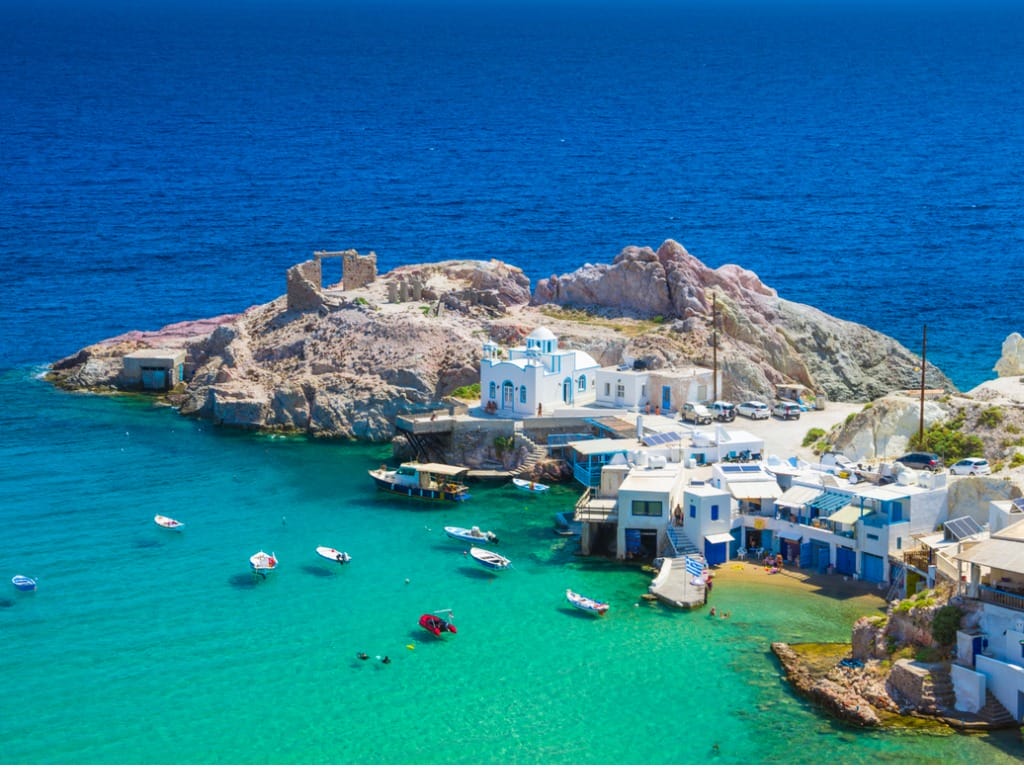 Scenic Firopotamos village (traditional Greek village by the sea, the Cycladic-style) with sirmata - traditional fishermen's houses, Milos island, Cyclades, Greece.