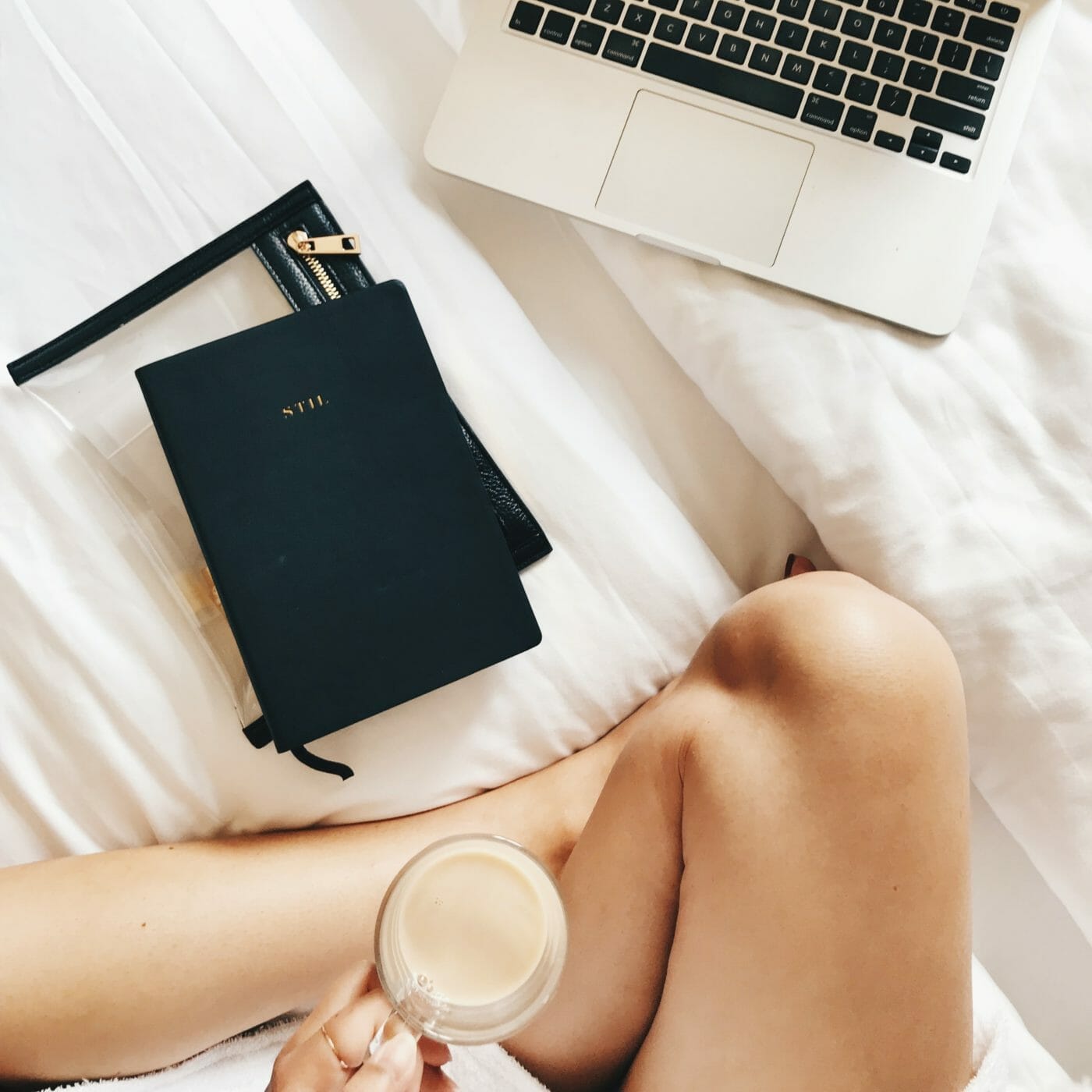 flatlay of a woman with her planner and computer being intentional on her mindful morning routine