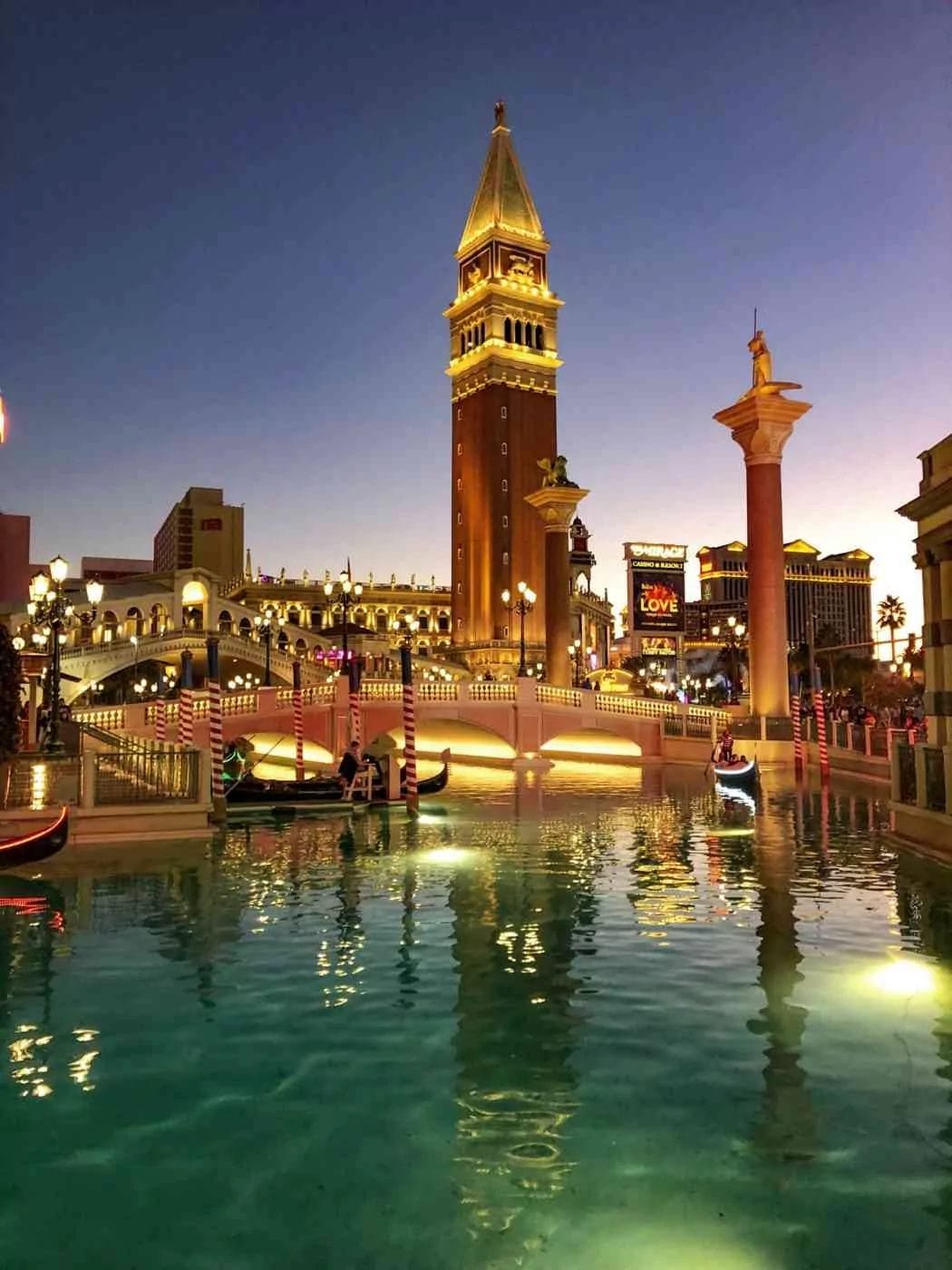 the venetian hotel and its saint mark's tower lit up at night in Las Vegas