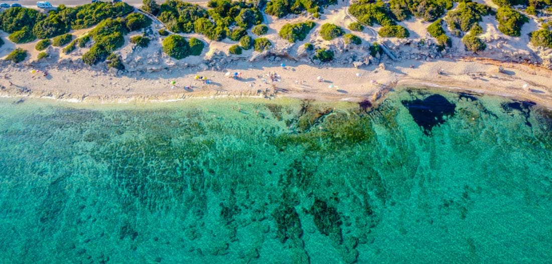 aerial view of turquoise waters of the Punta Prosciutto Coast in Salento, Puglia