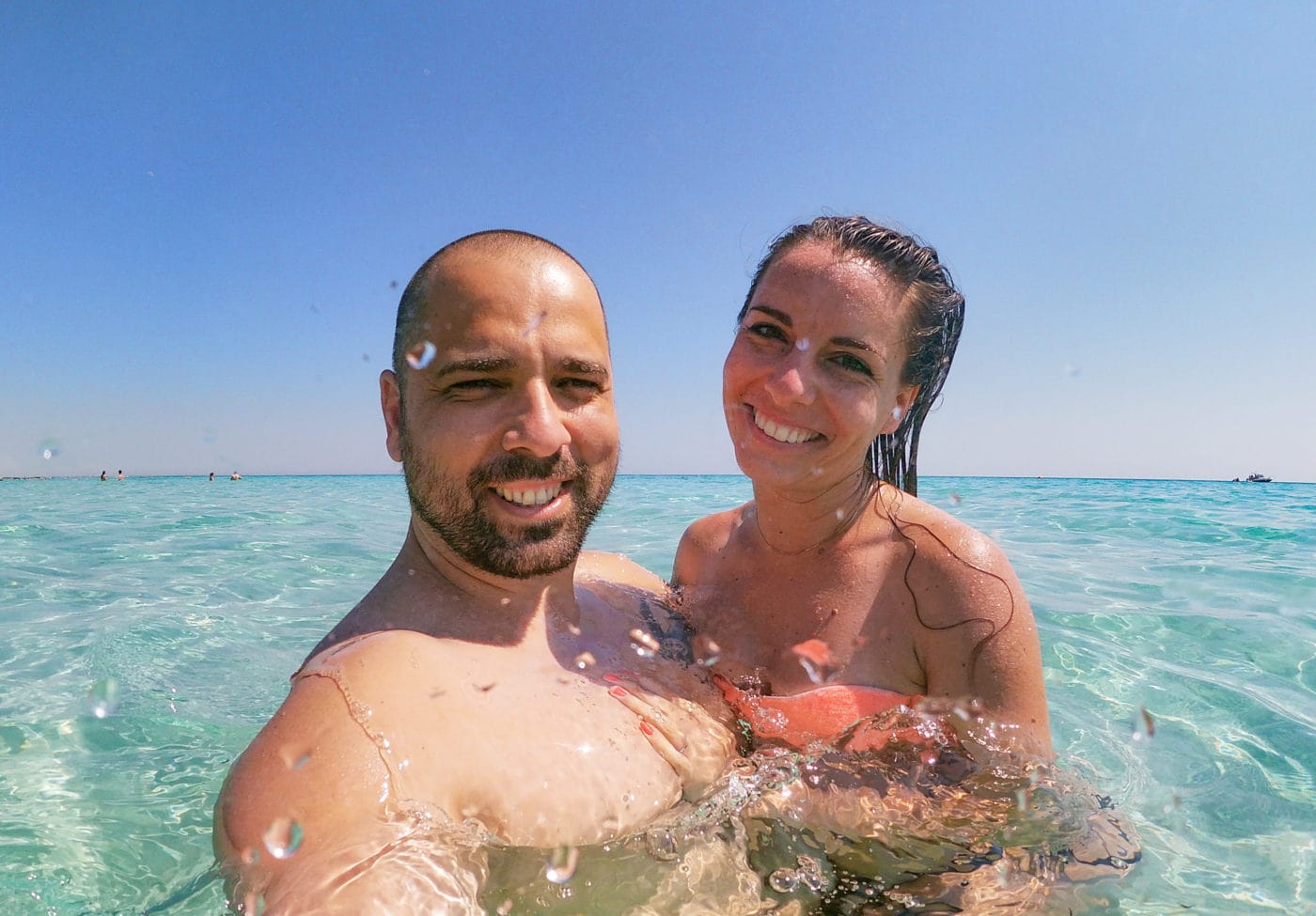 couple posing for a selfie in the sea water