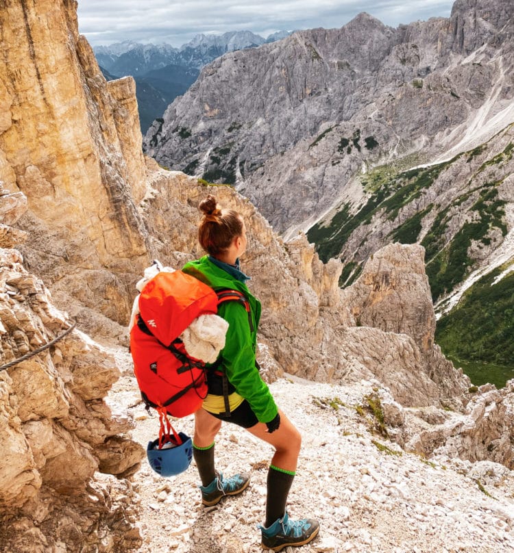 woman hiker gazing out on the cadini mountain group in the dolomites italy