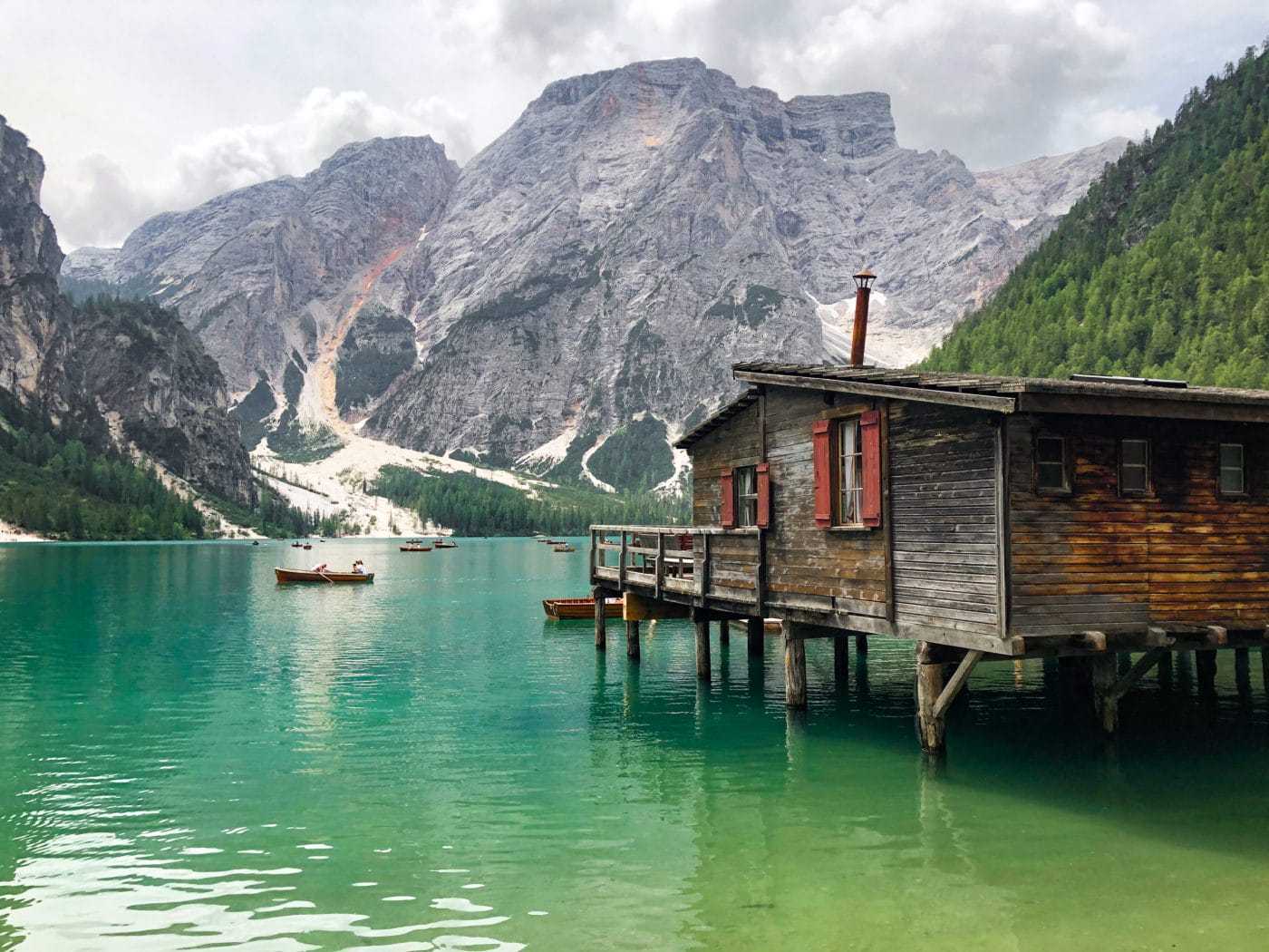 View of stunning emerald Lago di Braies (lake in the Dolomites) from the northside of the circuit trail