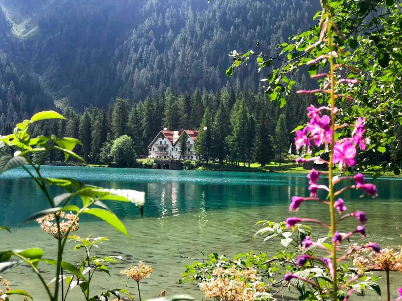 a cottage lake hotel on the banks of the turquoise Anterselva lake in the Dolomites Italy