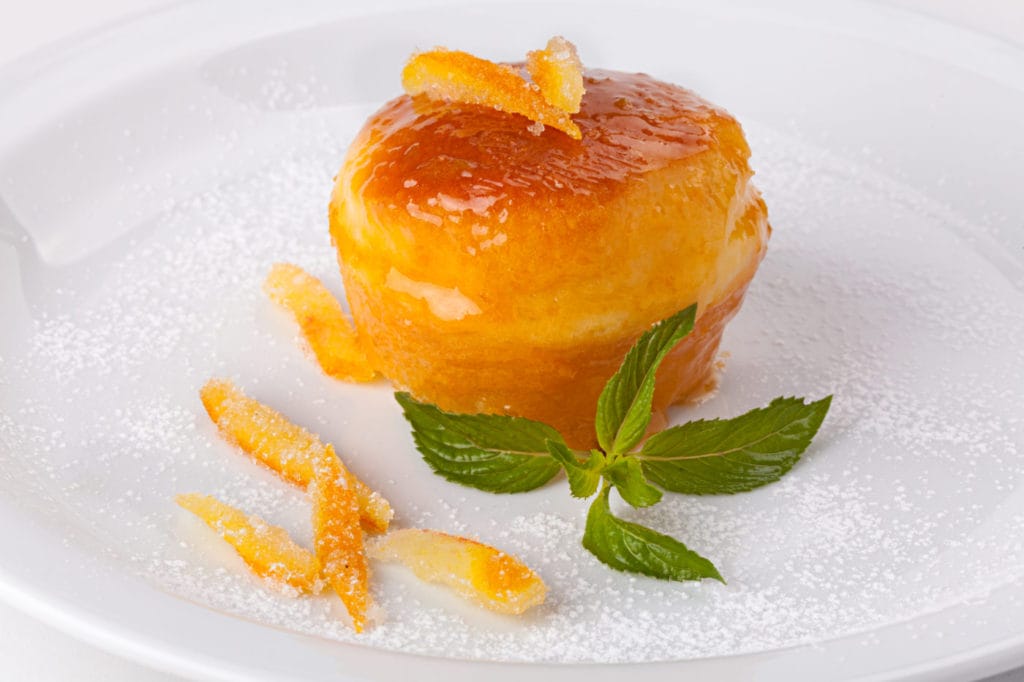 talian sweet Baba of Naples with candied fruit and mint leaves.
