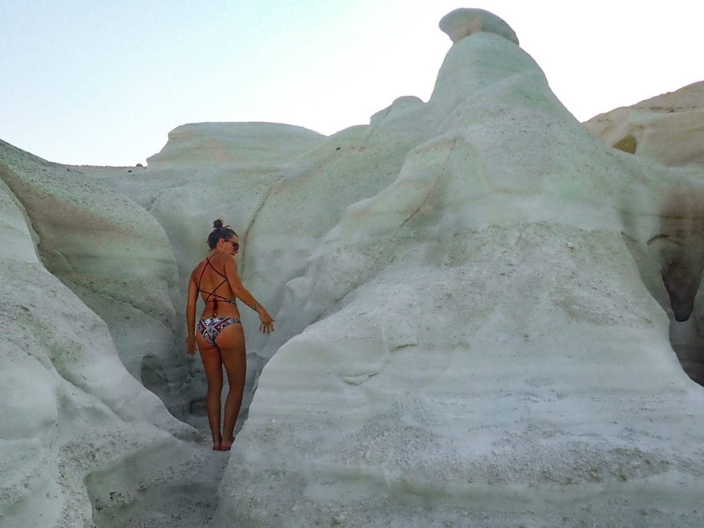 woman exploring the different passages of sarakiniko beach in milos