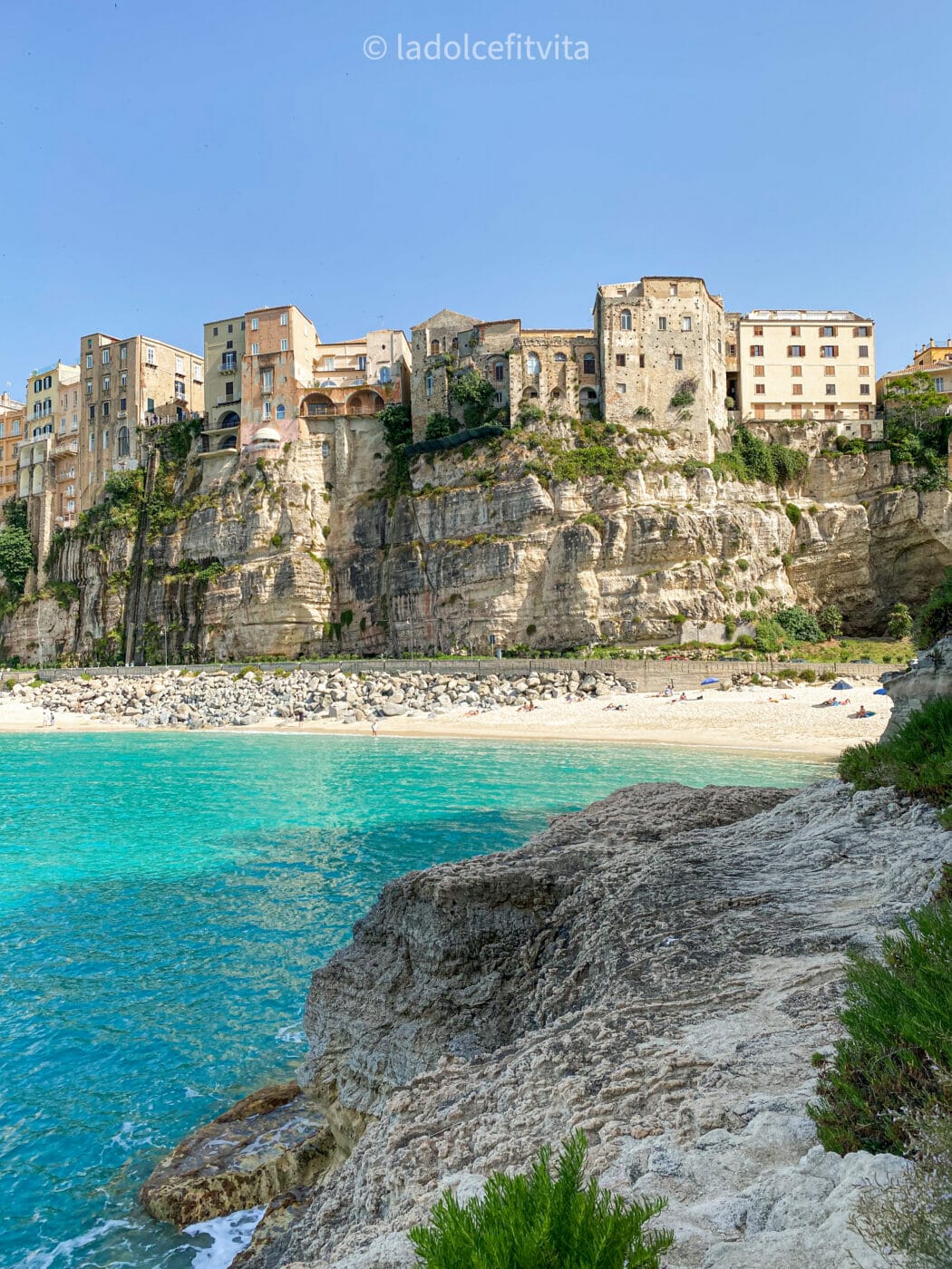 view from the Calabrian sea of the quaint beachside town of Tropea and its turquoise waters, Calabria Italy