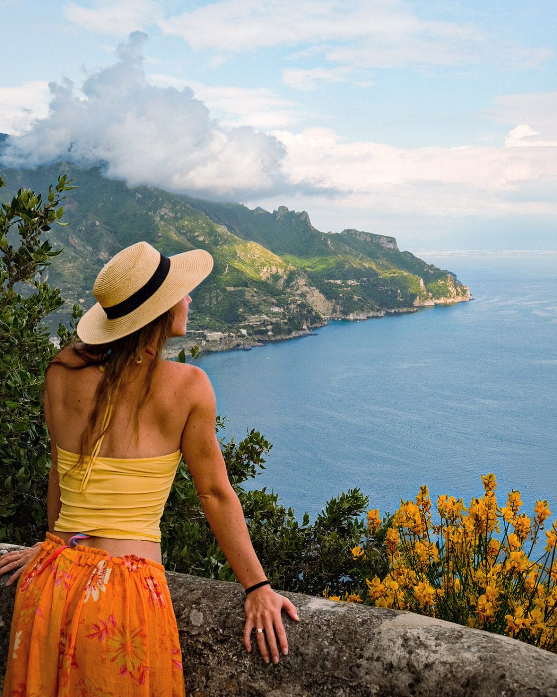 Girl in hat overlooking the bay in Ravello, Italy from Villa Cimbrone as decorative imagery for the post titled "dont make these mistakes in italy"