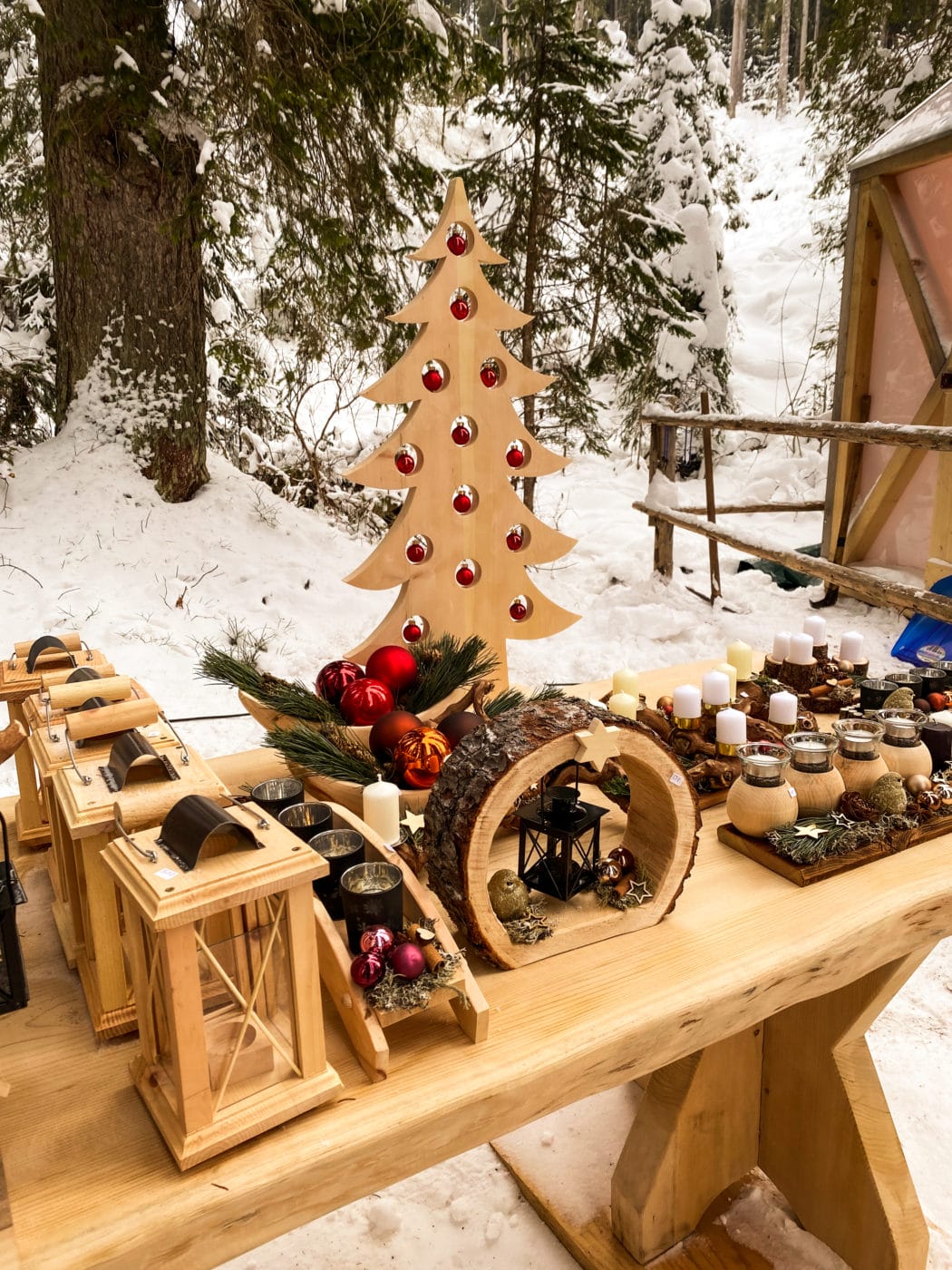 handcrafted wooden sculptures for sale at a christmas market in the dolomites