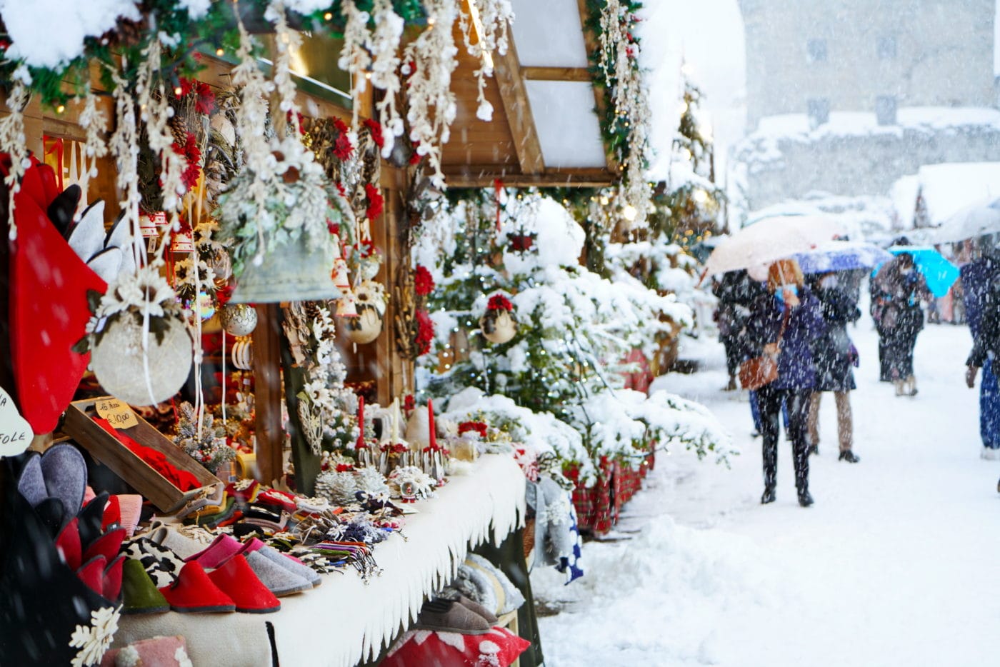 Traditional Christmas market under heavy snowfall. Aosta, Italy -December 2021