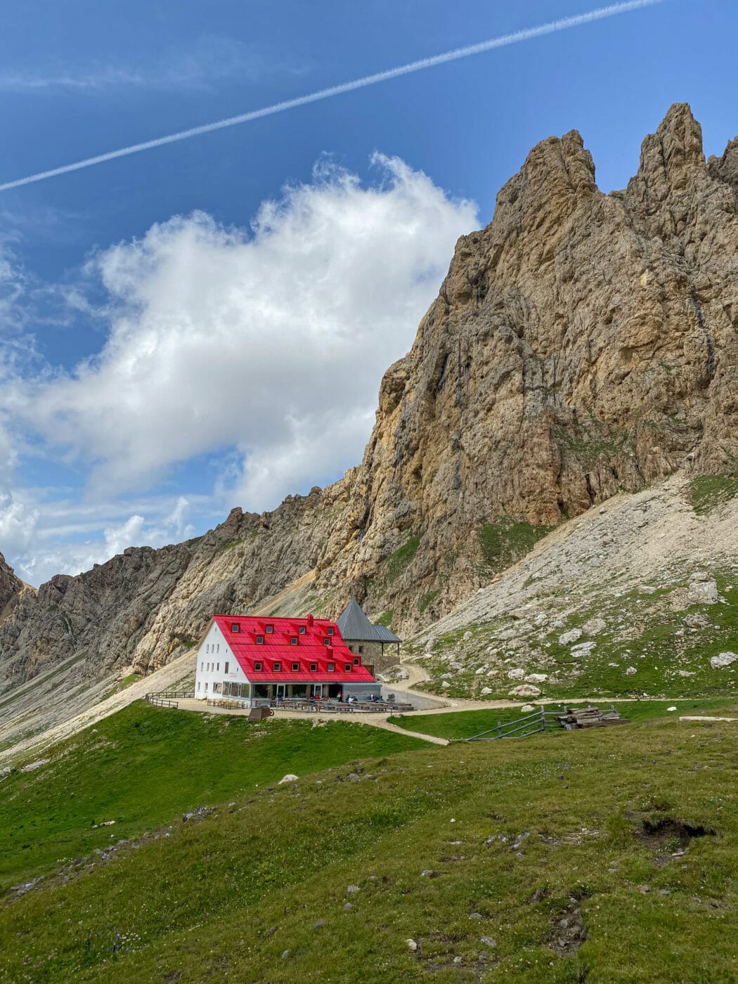 Red-roofed mountain hut in Alpe di Siusi Dolimites