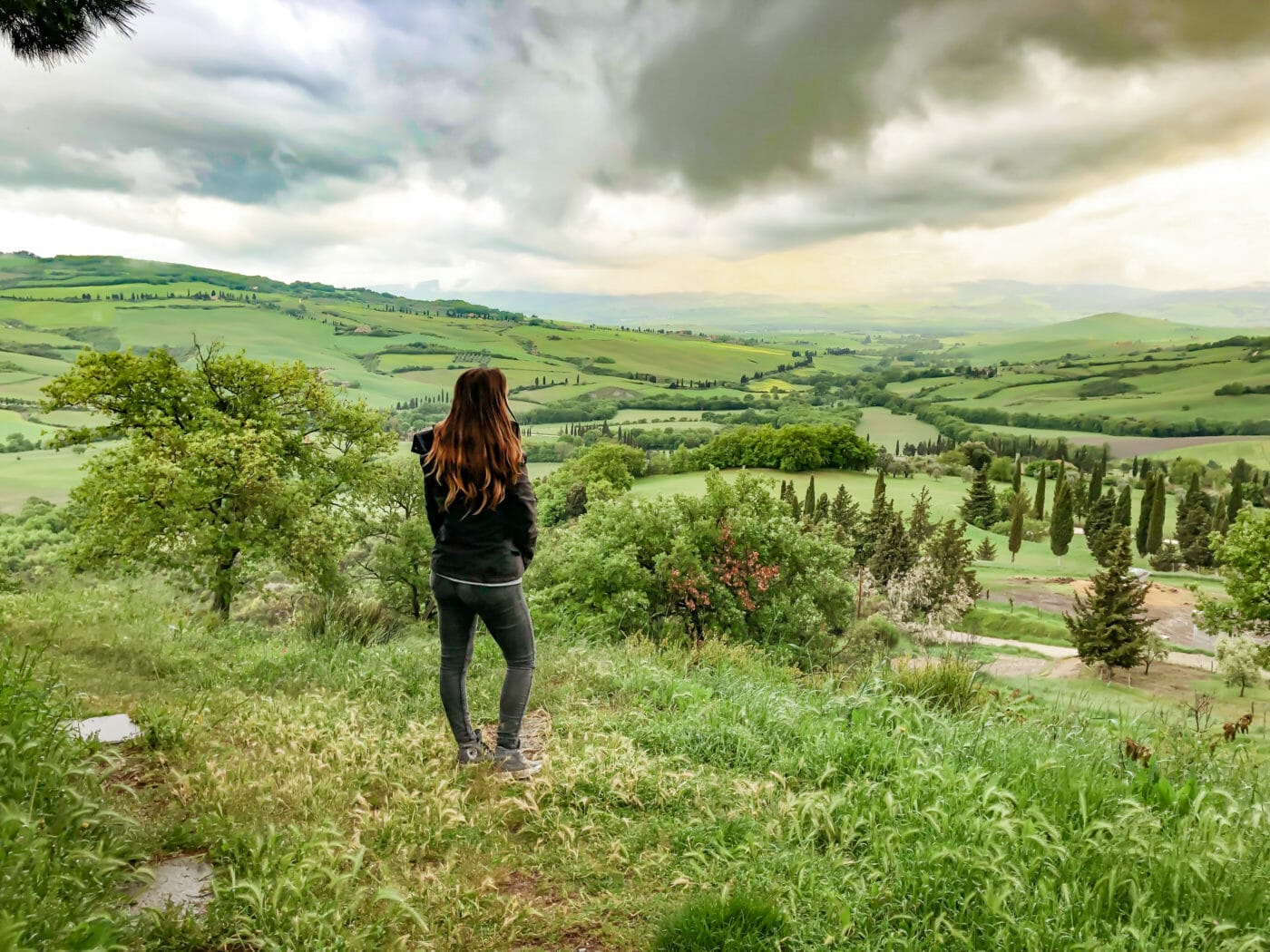 woman gazing at the rolling tuscan hills