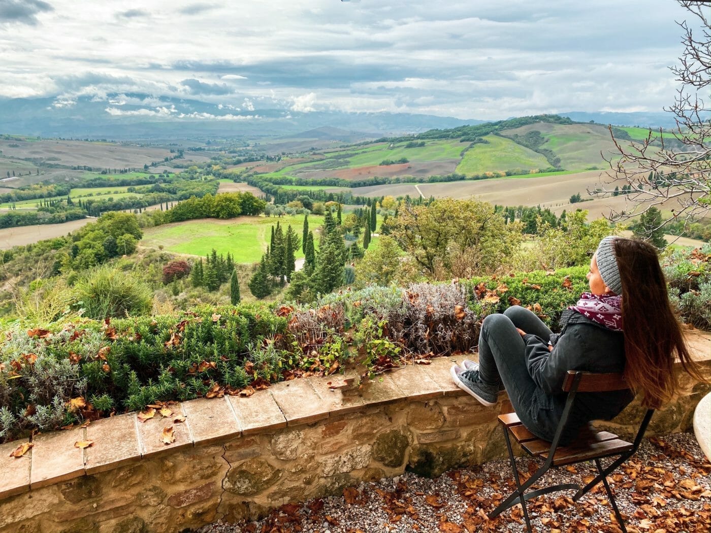 a woman looking out on the rolling Tuscan hills of the countryside near Pienza