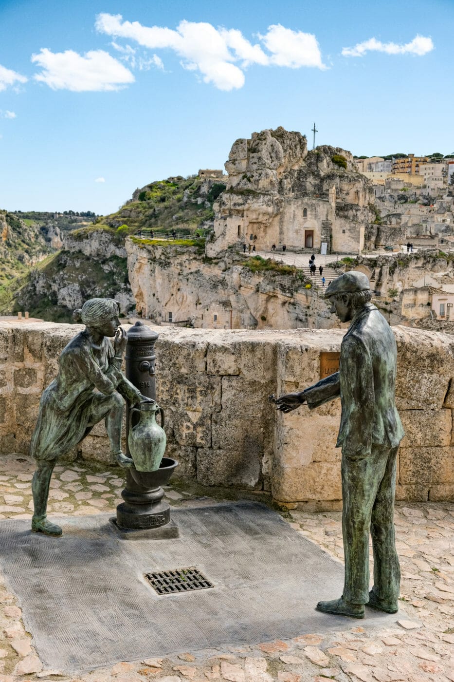 beautiful fountain depicting a man handing a rose to a woman gathering water in matera italy