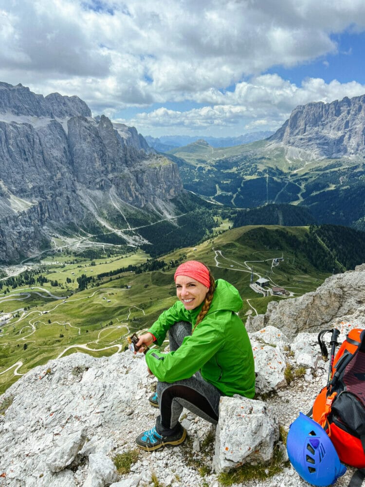woman hiker eating a snack at the top of Gran Cir in the Dolomites