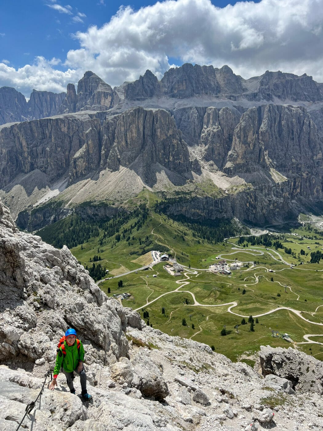 woman hiker posing for a picture as she stops to rest on a via ferrata in gran cir
