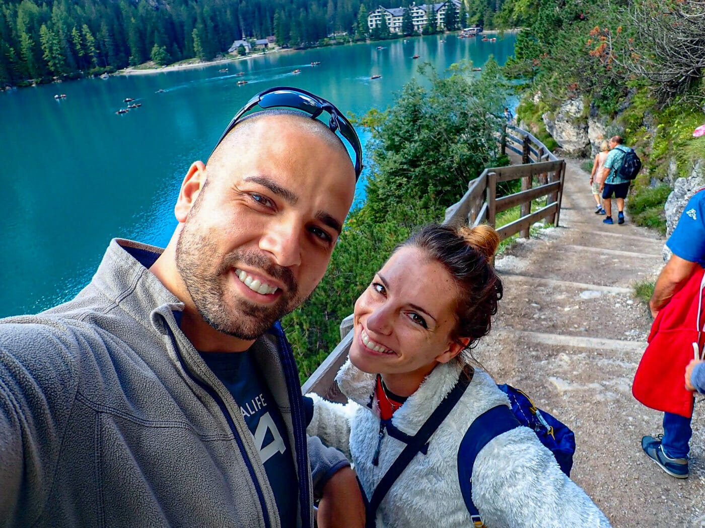 couple posing for a selfie on the dirt steps of Lago di Braies in the Italian Dolomites