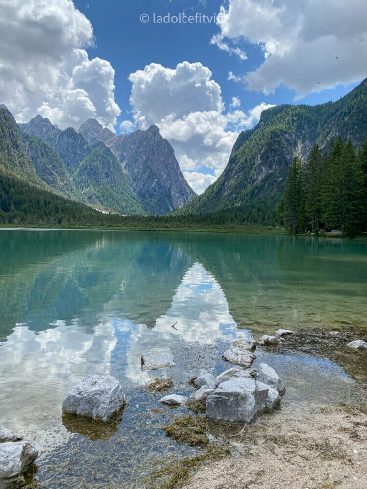 turquoise waters and mountain views at lago di dobbiaco in south tyrol italian dolomites