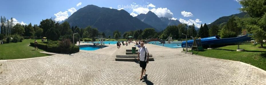 panoramic view of the 4 pools of Dolomitenbad Pools and Water park in Lienz Austria with mountains in the background