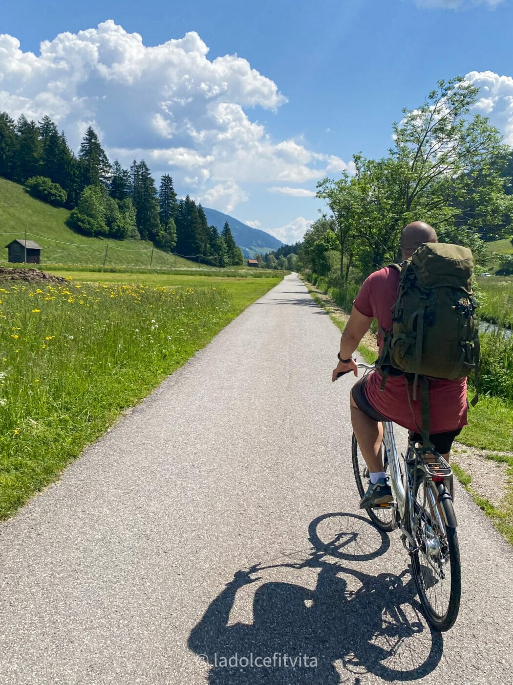 male cyclist on a beautiful bike trail in the dolomites that crosses the Italian-Austrian border from the town of Dobbiaco (Italy), to the town of Lienz (Austria)