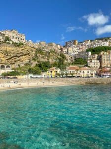 view of turquoise water and beach in seaside town Pizzo Calabria in Italy as seen from the marina