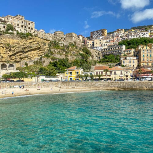 view of turquoise water and beach in seaside town Pizzo Calabria in Italy as seen from the marina