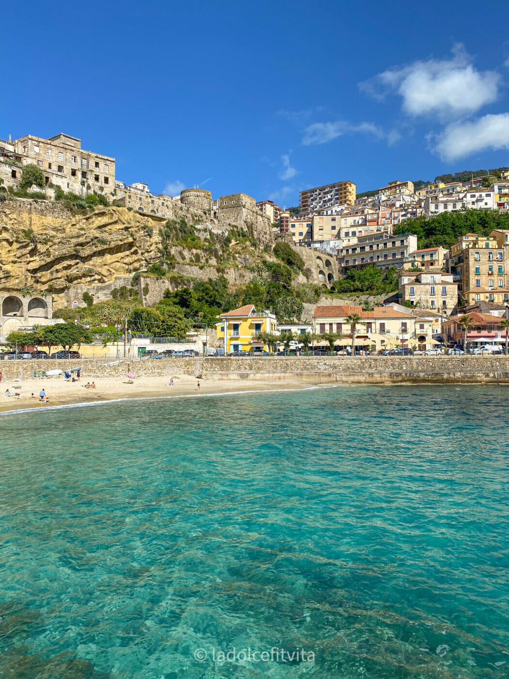 view of turquoise water and beach in seaside town Pizzo Calabria in Italy as seen from the marina