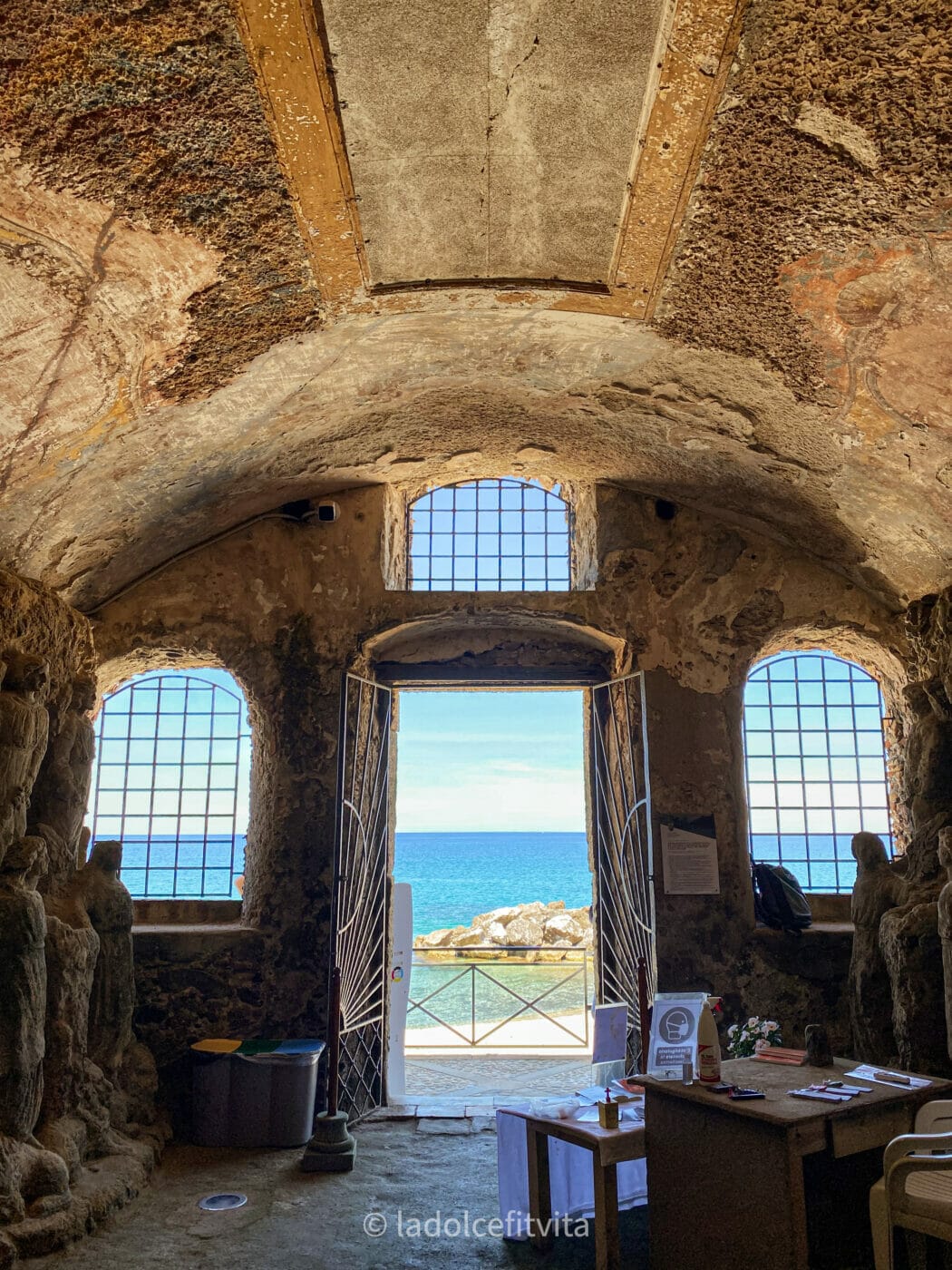 views of a turquoise sea from the interior of Piedigrotta Church in Pizzo Calabria