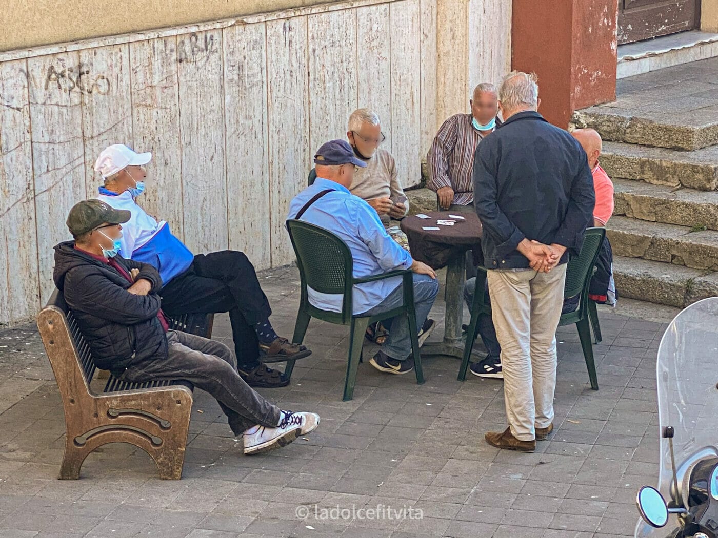 Italian men gathered in the town square to play cards - Pizzo Calabro