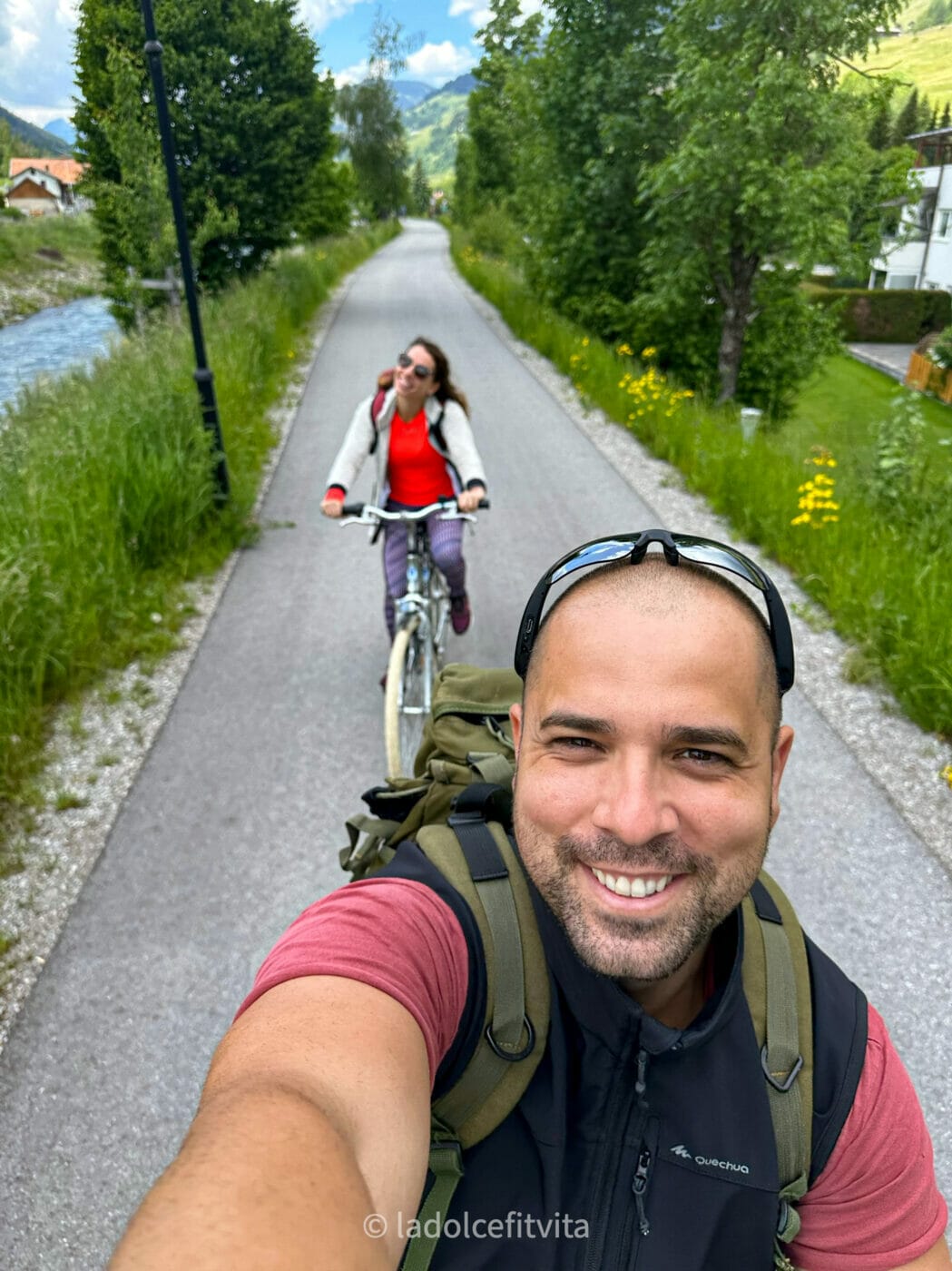 a couple on their bikes, taking a selfie while riding down the San Candido Lienz bike path