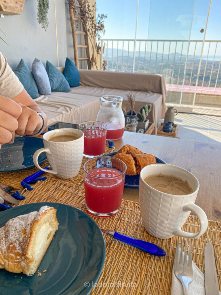 breakfast on a terrace with coffee, red-orange juice and cake
