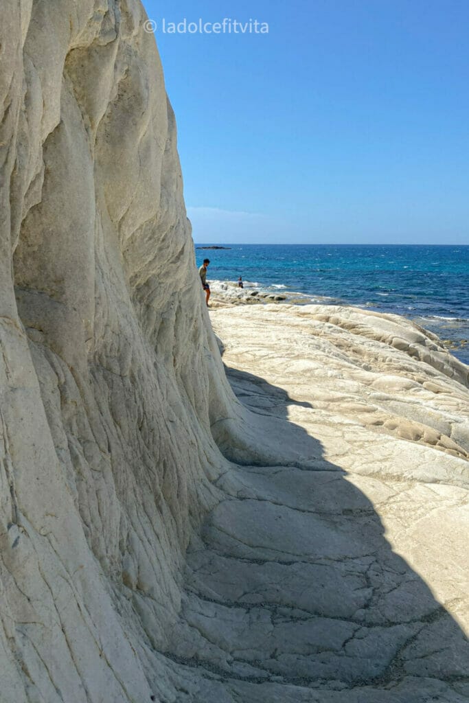 white cliffside rocks at the beach in sicily - punta bianca beach