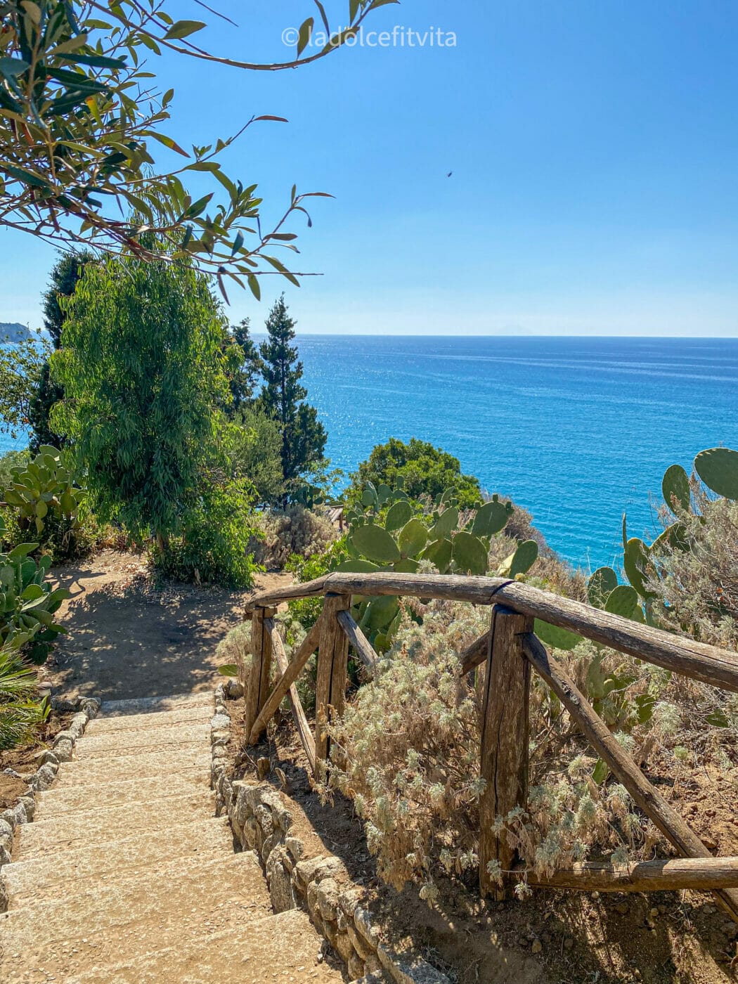 a stone staircase on the edge of isola bella in tropea leading to the gardens of the sanctaury santa maria dell'isola