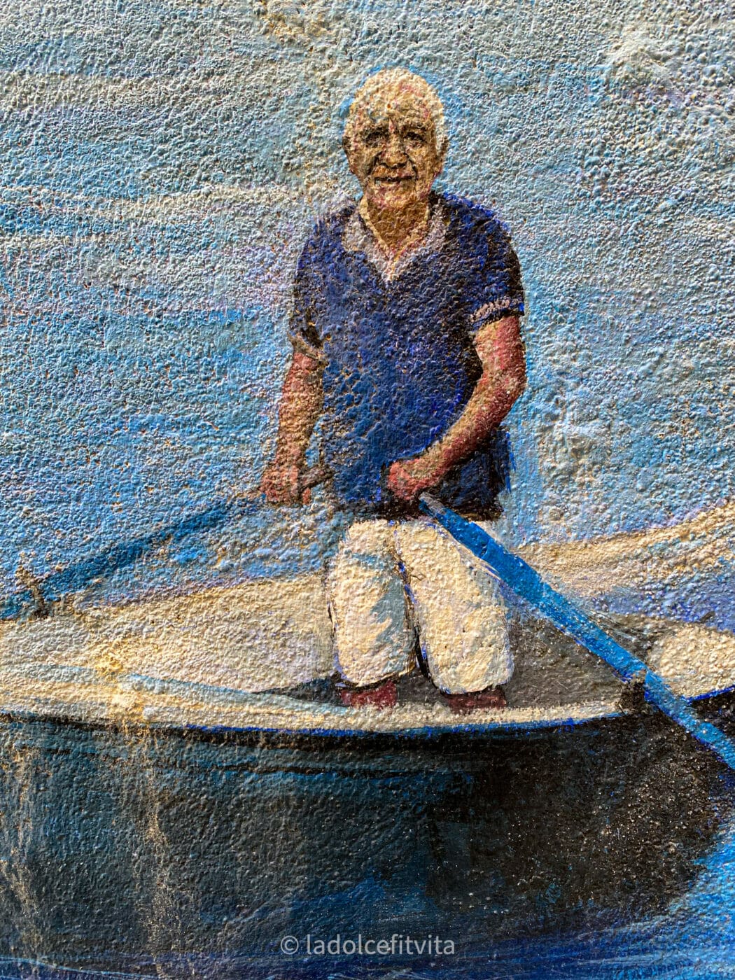 details of a mural depicting a fisherman rowing a boat, Diamante Italy